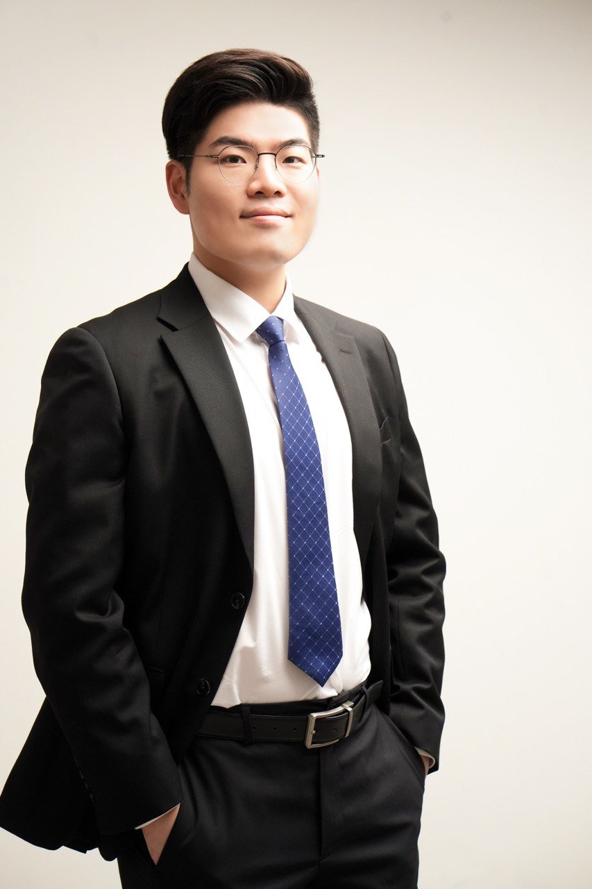 Dr. Mark Kwon standing in a dark suit.